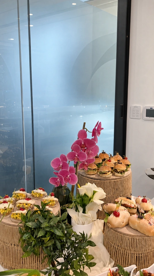 Event buffet floral arrangement with individual food presentation