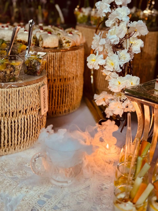 Canape display with white orchids, woven stands and glass vegetable cups
